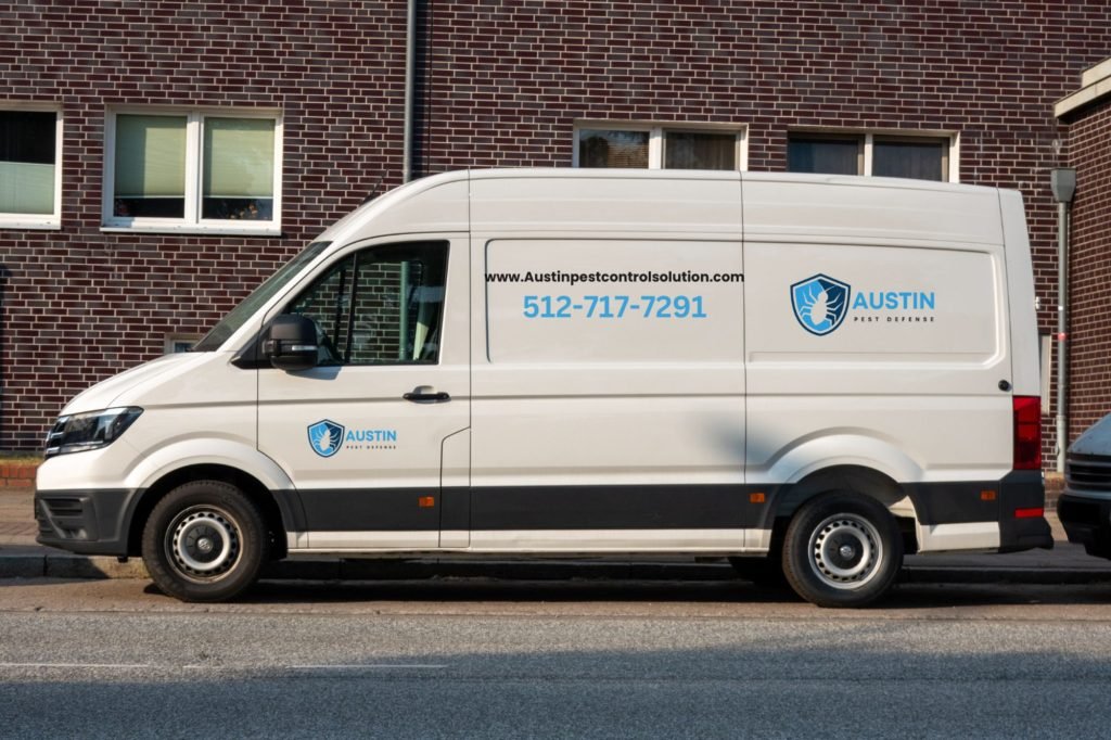 A white van parked outside a pest control service establishment in Austin, Texas.